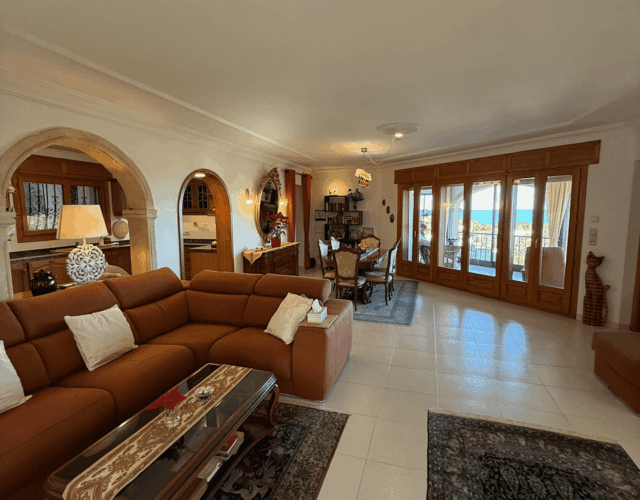 Main floor living room with ocean view through windows.