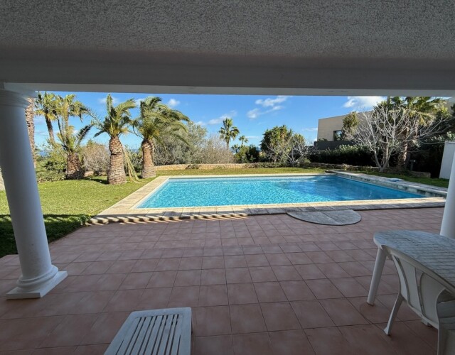 View of pool area, along with patio from lower floor