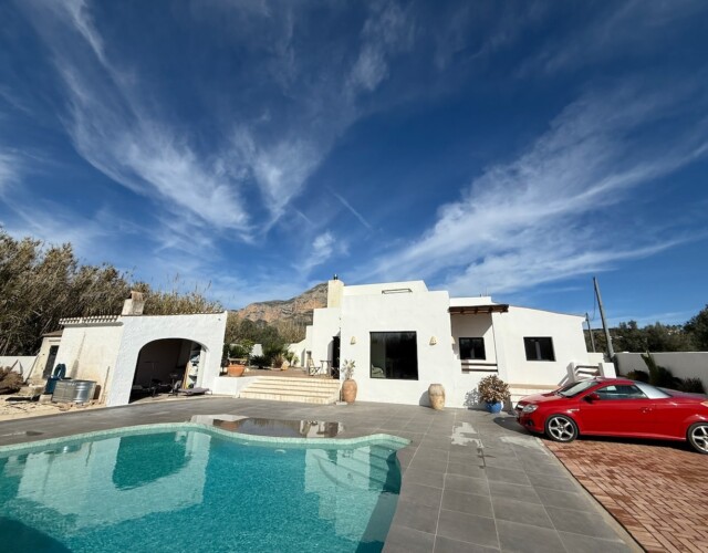 Parking area and front of the home with pool