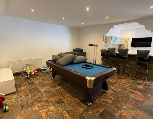 Pool/entertainment room on lower level with kitchen