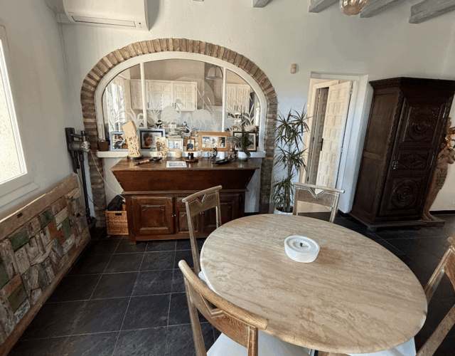 Main floor dining area with kitchen behind