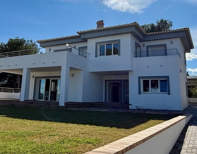 Front of house with 4 car carport