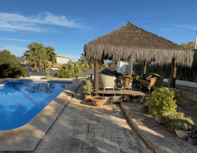 Covered sitting area by pool